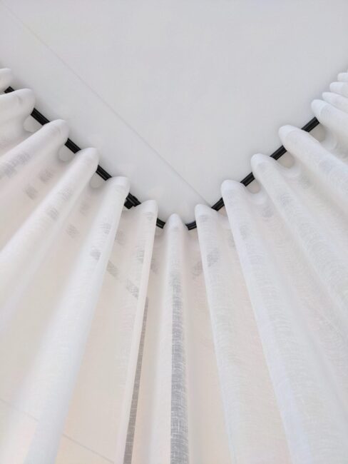 White curtains and black cornice